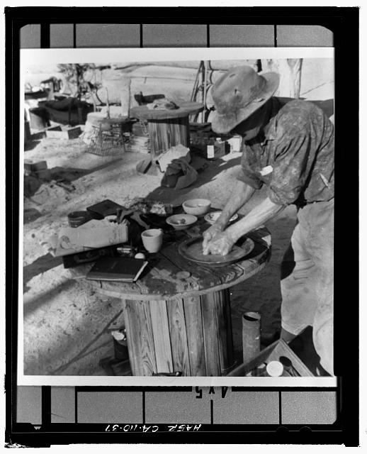 37.  HISTORIC PHOTOGRAPH SHOWING BILL KEYS PROBABLY WRINGING AMALGAM IN CHAMOIS, FORCING MERCURY INTO GOLD PAN. - Wall Street Gold Mill, Twentynine Palms, San Bernardino County, CA