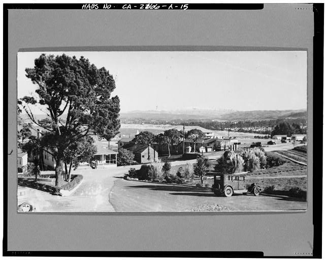 15.  NORTHEAST CORNER, SOLDIER FIELD, LOOKING SOUTHEAST TOWARD THE GYMNASIUM, SHOWING EAST DITCH AND A SECTION OF LOW WALL. No date, probably ca. 1935. Photographer unknown. Original silver gelatin print measures 13.1 cm by 7.3 cm, flush mounted on mat board. - Presidio of Monterey, Soldier Field, Monterey, Monterey County, CA