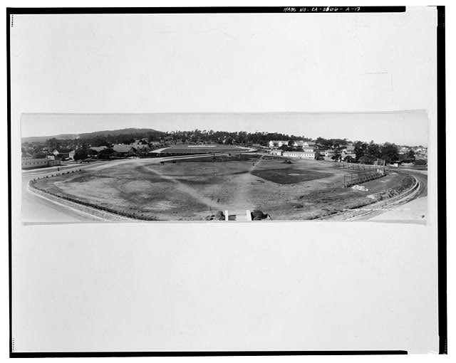 17.  'BIRDSEYEVIEW, PRESIDIO OF MONTEREY, CAL., JAN. 1938.' No signature, photographer probably Anton C. Heidrick. This panoramic view looks west over Soldier Field from the upper floor or roof of the gymnasium. Original cool toned silver gelatin print measures 85.1 cm by 22.4 cm, flush mounted on mat board. - Presidio of Monterey, Soldier Field, Monterey, Monterey County, CA