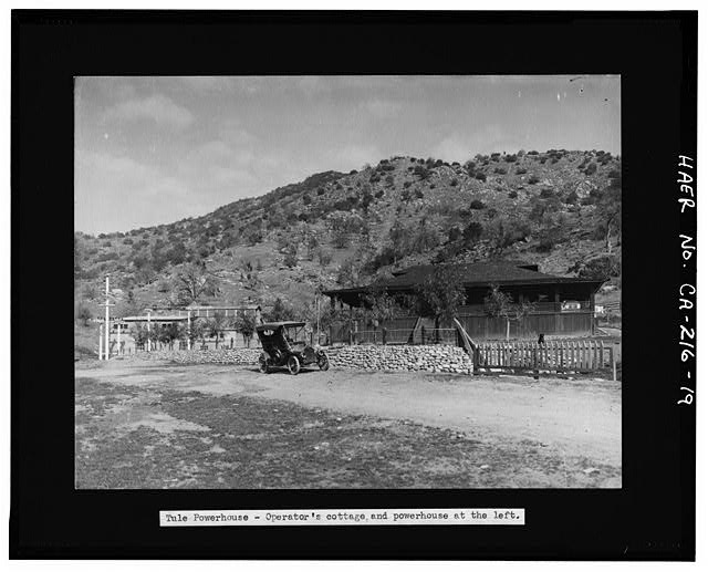19.  Photocopy of photograph (original copy in Edison collection). Photographer and date unknown, although probably taken before 1920. SOUTH SIDE OF TULE RIVER POWERHOUSE COMPLEX SHOWING OPERATOR COTTAGE AT PHOTO RIGHT AND POWERHOUSE AND TRANSFORMER BUILDING IN BACKGROUND AT PHOTO LEFT. LINE OF BURIED PENSTOCK IS VISIBLE ON SIDE OF HILL AT PHOTO CENTER. VIEW TO NORTH. - Tule River Hydroelectric Project, Water Conveyance System, Middle Fork Tule River, Springville, Tulare County, CA