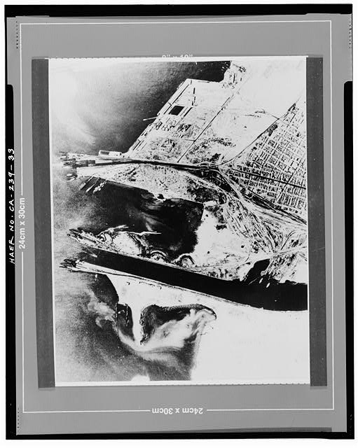 33.  NEARLY VERTICAL AERIAL VIEW OF THE MOUTH OF THE FEDERAL CHANNEL, LOOKING TO THE NORTHWEST. NEITHER ALAMEDA NAVAL AIR STATION NOR OAKLAND NAVAL SUPPLY CENTER HAVE BEEN BUILT. No date, probably mid-1930's.  U.S. Navy photograph. Original print on file at the National Archives, San Bruno, California. - Oakland Harbor Training Walls, Mouth of Federal Channel to Inner Harbor, Oakland, Alameda County, CA