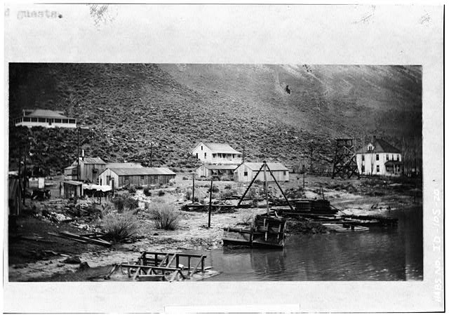 20.  VIEW OF RESIDENTIAL BUILDINGS TAKEN IN 1911 LOOKING NORTHEAST PROBABLY FROM SWAN FALLS DAM. FROM LEFT TO RIGHT, RESIDENTIAL BUILDINGS ARE COTTAGE 101, THE COTTAGE THAT BURNED IN 1921 (AND WAS REPLACED WITH COTTAGE 231), AND THE CLUB HOUSE. OTHER BUILDINGS IN FOREGROUND ARE STOREHOUSES AND SHOPS. - Swan Falls Village, Snake River, Kuna, Ada County, ID
