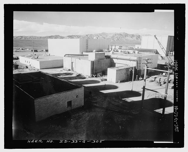 ETR, TRA-642.  ETR COMPLEX NEARLY COMPLETE.  CAMERA FACES NORTHWEST, PROBABLY FROM TOP DECK OF COOLING TOWER.  SHADOW IS CAST BY COOLING TOWER UNITS OFF LEFT OF VIEW.  HIGH-BAY REACTOR BUILDING IS SURROUNDED BY ITS ATTACHED SERVICES:  ELECTRICAL (TRA-648), HEAT EXCHANGER (TRA-644 WITH U-SHAPED YARD), AND COMPRESSOR (TRA-643).  THE CONTROL BUILDING (TRA-647) ON THE NORTH SIDE IS HIDDEN FROM VIEW.  AT UPPER RIGHT IS MTR BUILDING, TRA-603.  INL NEGATIVE NO. 56-3798.
Jack L. Anderson, Photographer, 11/26/1956 - Idaho National Engineering Laboratory, Test Reactor Area, Materials & Engineering Test Reactors, Scoville, Butte County, ID