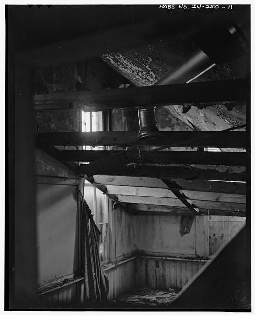 11.  Detail of the interior, looking through an interior doorway toward the front and east window. Note: This photograph shows that the building had been converted to a residence following its use as a school. In addition, the hazardous condition of the structure's interior is evident. Two ceilings which are visible in the photograph, (the upper, probably original plastered ceiling, and a secondary, adapted ceiling) as well as ceiling joists in the southernmost rooms have collapsed. Because of the dangerous condition of the interior of the building, additional interior photography was not attempted at this time. - Perry Township School No. 3, Middle Mount Vernon & Eickhoff Roads, Evansville, Vanderburgh County, IN