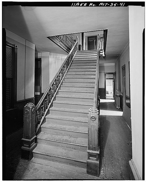 41.  Staircase in an unidentified building. Many boarding houses and lodgings were built with central stairwells and double loaded hallways which were lit by skylights. This is probably the interior of a building constructed in the 1890s, when more elegant housing was constructed than had been previously. - Butte Historic District, Bounded by Copper, Arizona, Mercury & Continental Streets, Butte, Silver Bow County, MT