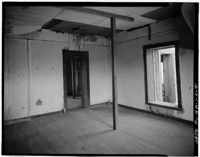 41.  MCDONALD RANCH: INTERIOR OF NORTHEAST ROOM OF RANCH HOUSE, LOOKING NORTHWEST. TAPE HANGING FROM CEILING/WALL JOINT IS PROBABLY LEFT FROM SEALING OF ROOM PRIOR TO ASSEMBLY OF PLUTONIUM CORE COMPONENTS ON JULY 13, 1945 - White Sands Missile Range, Trinity Site, Vicinity of Routes 13 & 20, White Sands, Dona Ana County, NM