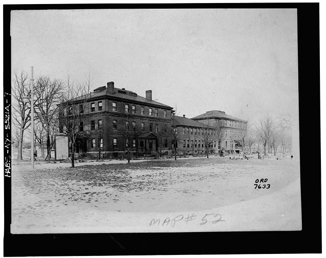 7.  Photograph of a photograph in possession of the Watervliet Arsenal Museum, New York. EAST (FRONT) ELEVATION OF UNITS 2, 3, AND 4. PROBABLY TAKEN ABOUT 1918. - Watervliet Arsenal, Building No. 10, Buffington Street West of Dalliba Avenue, Watervliet, Albany County, NY