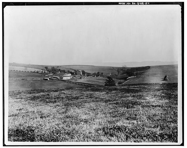 24.  GENERAL VIEW FROM WEST: ROAD ACROSS MIDDLE FOREGROUND LEADS DIRECTLY SOUTH TO ROUTE 40; LINE ACROSS WOODLOT IN DISTANCE LEADS EAST TO UNIONTOWN, AND IS PROBABLY THE 1784 ROAD FROM UNIONTOWN TO BROWNSVILLE Photocopy of early 20th-century photograph Collection of Springer Homestead Archives, c/o Gerald Cunningham, Jessup, Maryland - Levi Springer House, Fan Hollow Road, Uniontown, Fayette County, PA