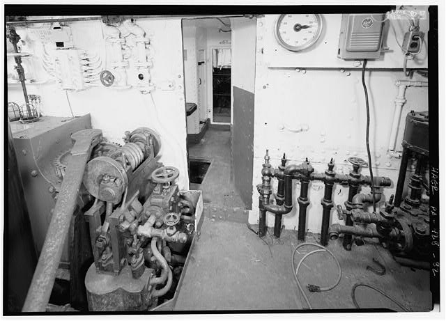 View forward, starboard engine room, compartment C-1; note RPM indicator at top right of photograph, bilge drain manifold at lower right; worm gear at left is probably part of a hydraulic reversing gear. (057) - USS Olympia, Penn's Landing, 211 South Columbus Boulevard, Philadelphia, Philadelphia County, PA