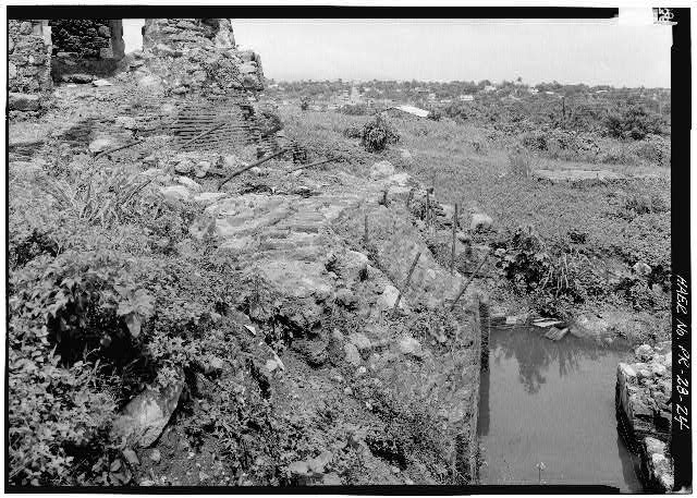 24.  Detail of ruins of brick foundation walls at base of windmill tower with threaded, iron rods (probably for bolting down machinery) sticking out. - Hacienda Azucarera Vives, Playita Machete, Guayama Municipio, PR