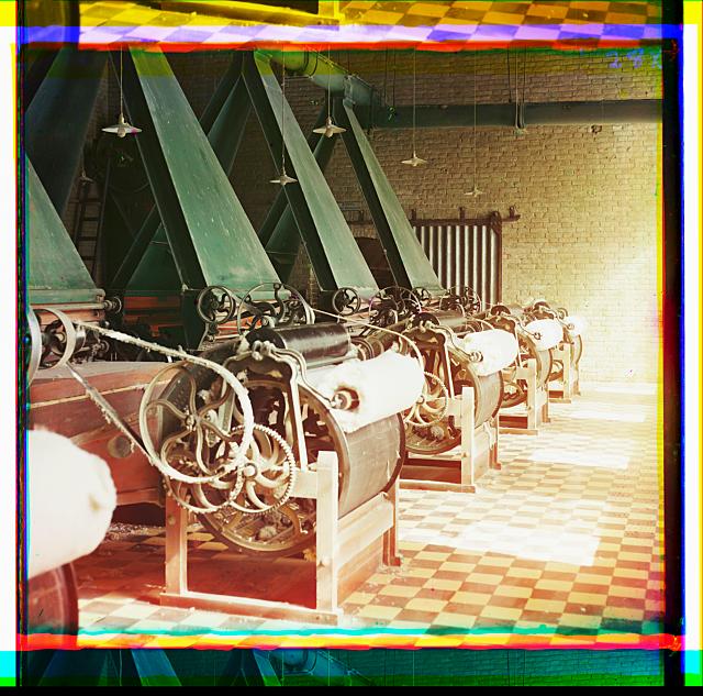 [Cotton textile mill interior with machines producing cotton thread, probably in Tashkent]