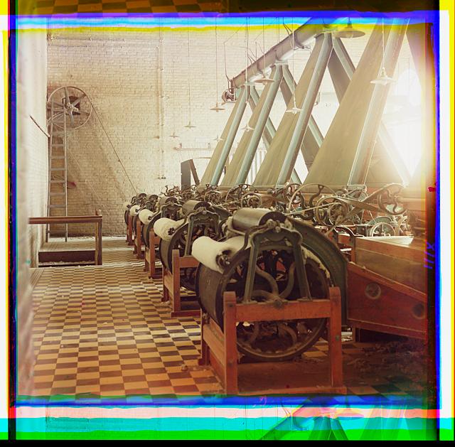 [Cotton textile mill interior with machines producing cotton thread, probably in Tashkent]