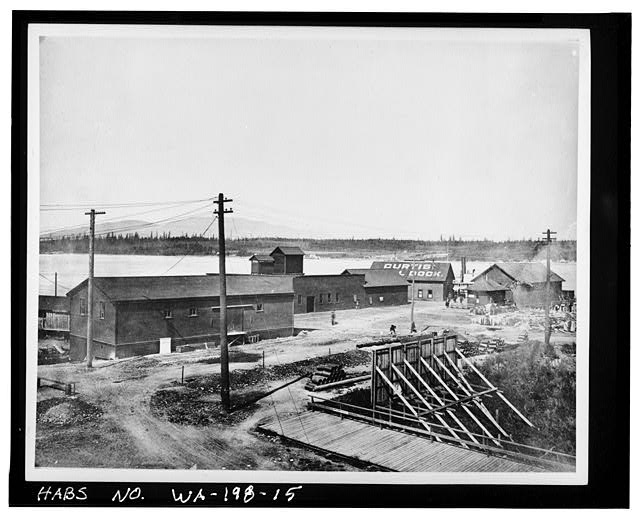 15.  Photocopy of photograph (Original print, Wallie V. Funk Collection.) Photographer unknown. Published in the Anacortes American, 12 October 1911; 'Plant of the Anacortes Ice Company and Curtis Dock.' Photograph probably earlier. View looking northwest, left to right; Cement and Plaster Warehouse; Ice Plant (with towers); Cold Storage Warehouse; Freight Warehouse; a warehouse; and early ticket office. - Curtis Wharf, O & Second Streets, Anacortes, Skagit County, WA